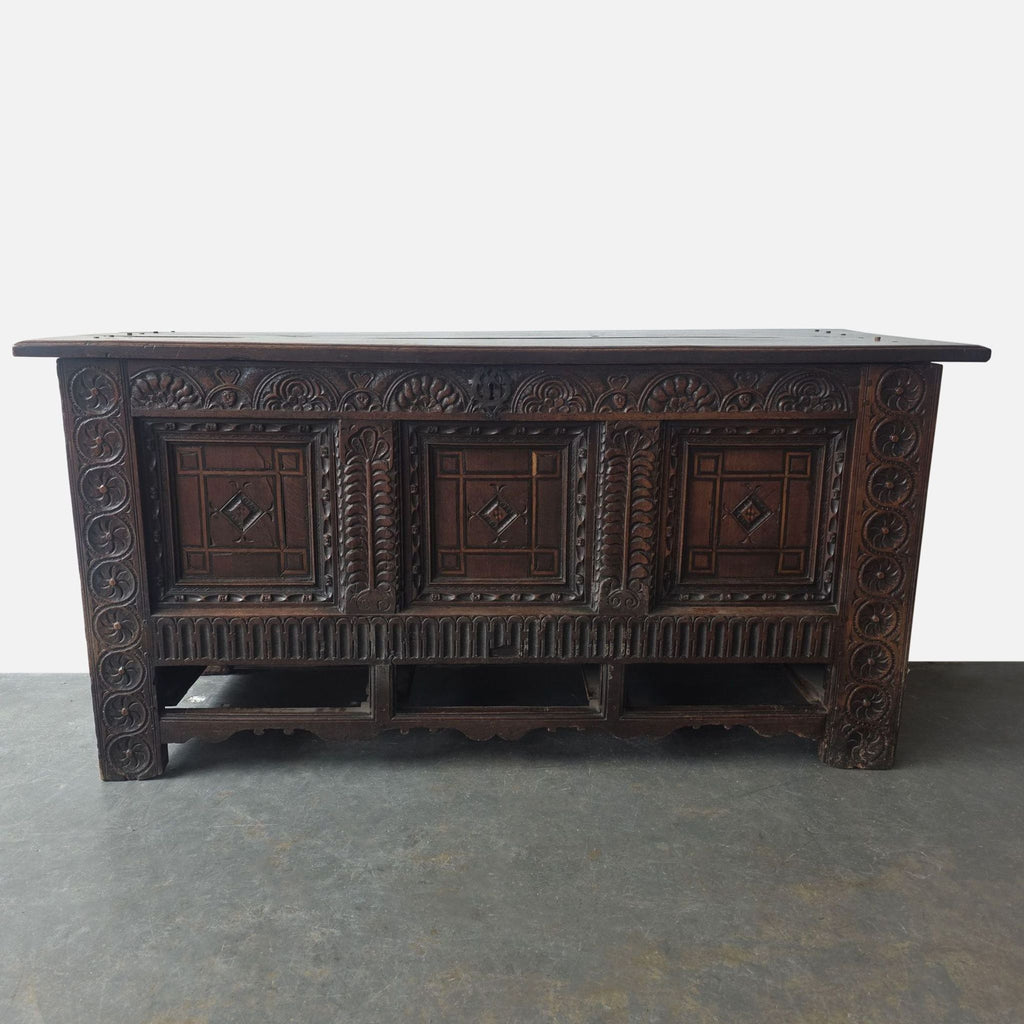 Antique 16th-century mule chest trunk with hand-carved wood details and missing lower drawers.