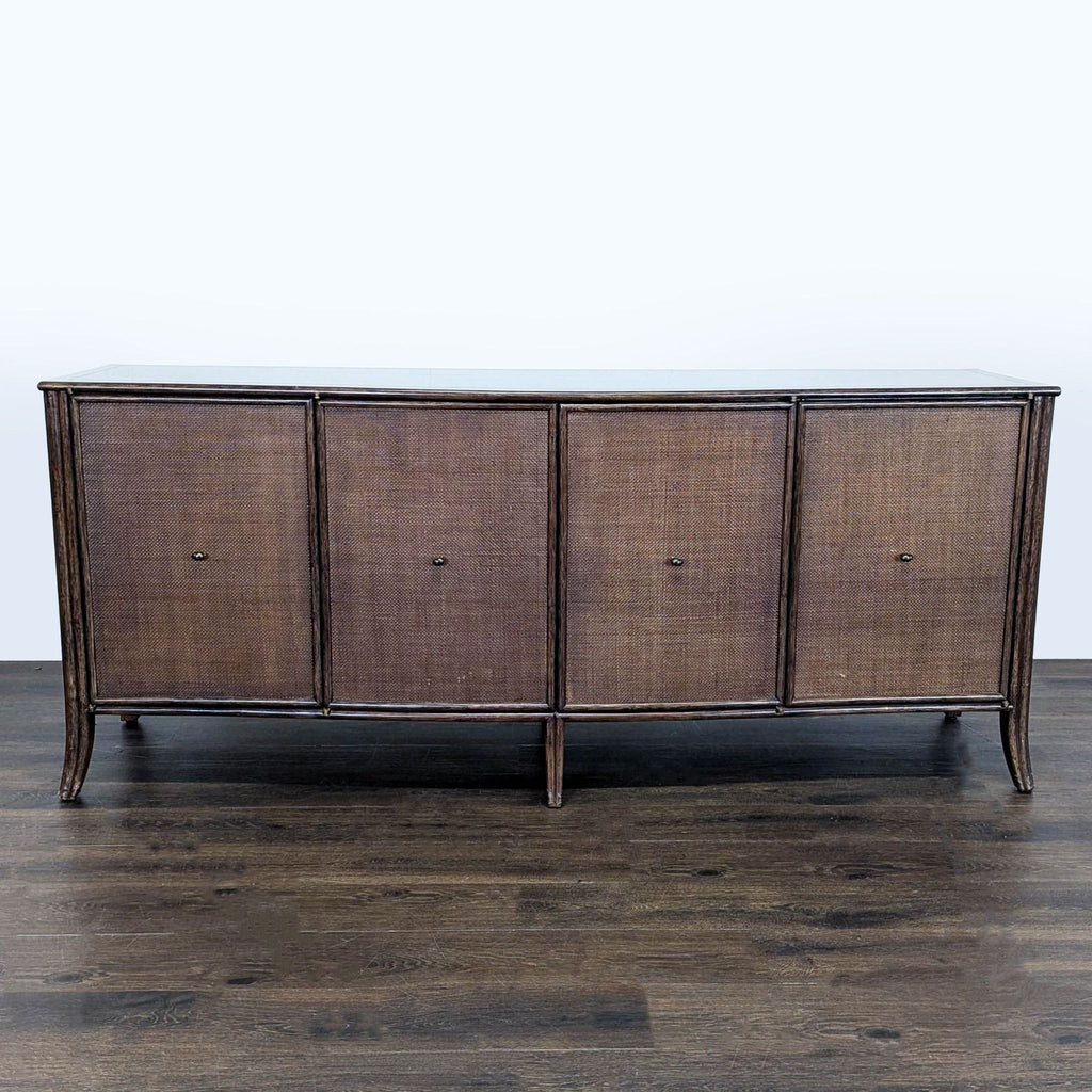 Large oak cabinet with woven raffia doors, rattan borders, and bowed front by McGuire/Baker, dark tobacco finish.  