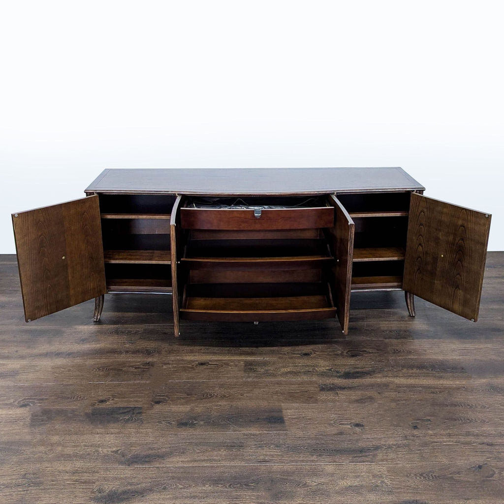 Textured dark oak case by McGuire/Baker featuring splayed legs, rattan accents, and woven raffia grass cloth veneer.  