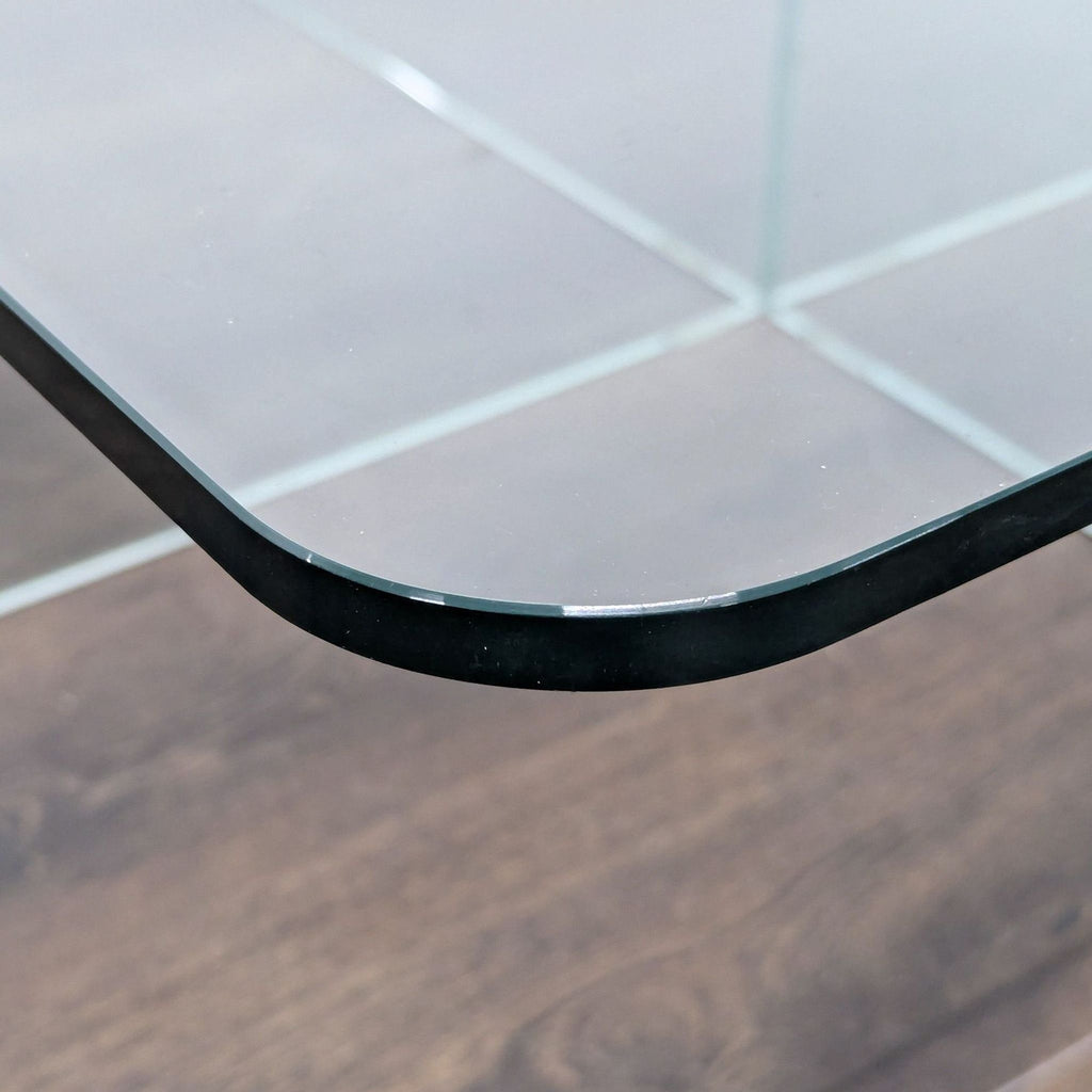 2. Corner detail of EQ3 glass coffee table, highlighting the rounded glass edge and transparency above wood floor.