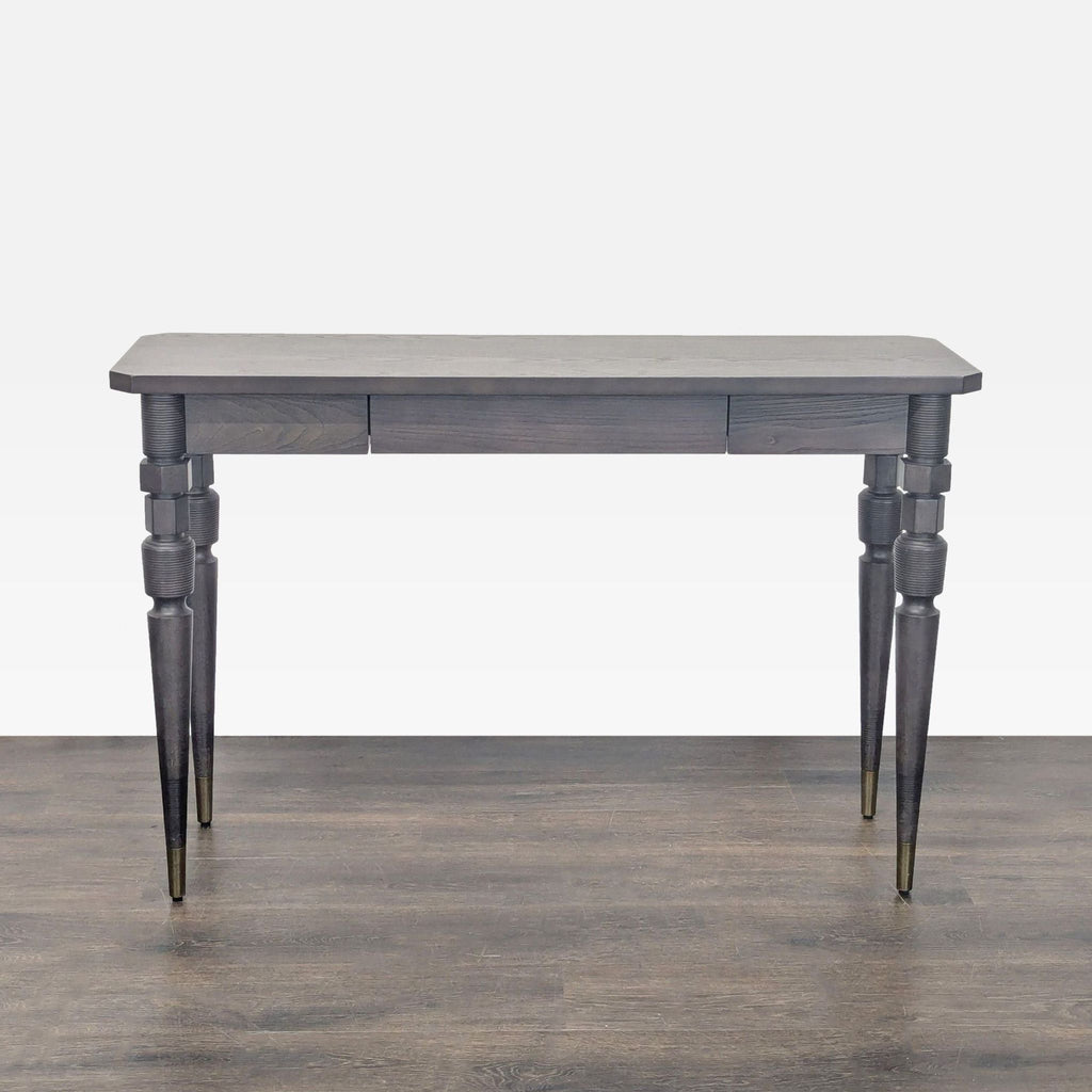 1. West Elm dark wood console table with decorative turned legs, shown on a wood floor with neutral background.