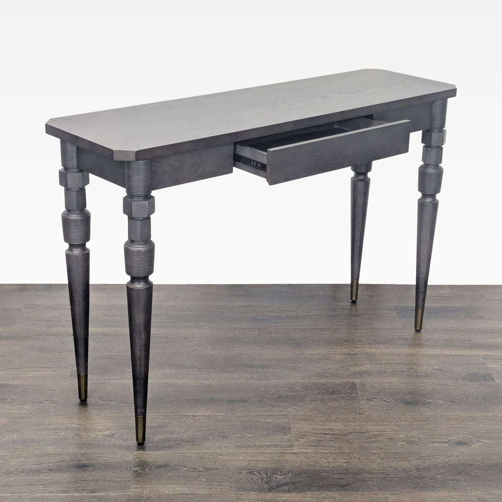 2. Angled view of a West Elm side table with a single drawer partially open, featuring unique carved legs.