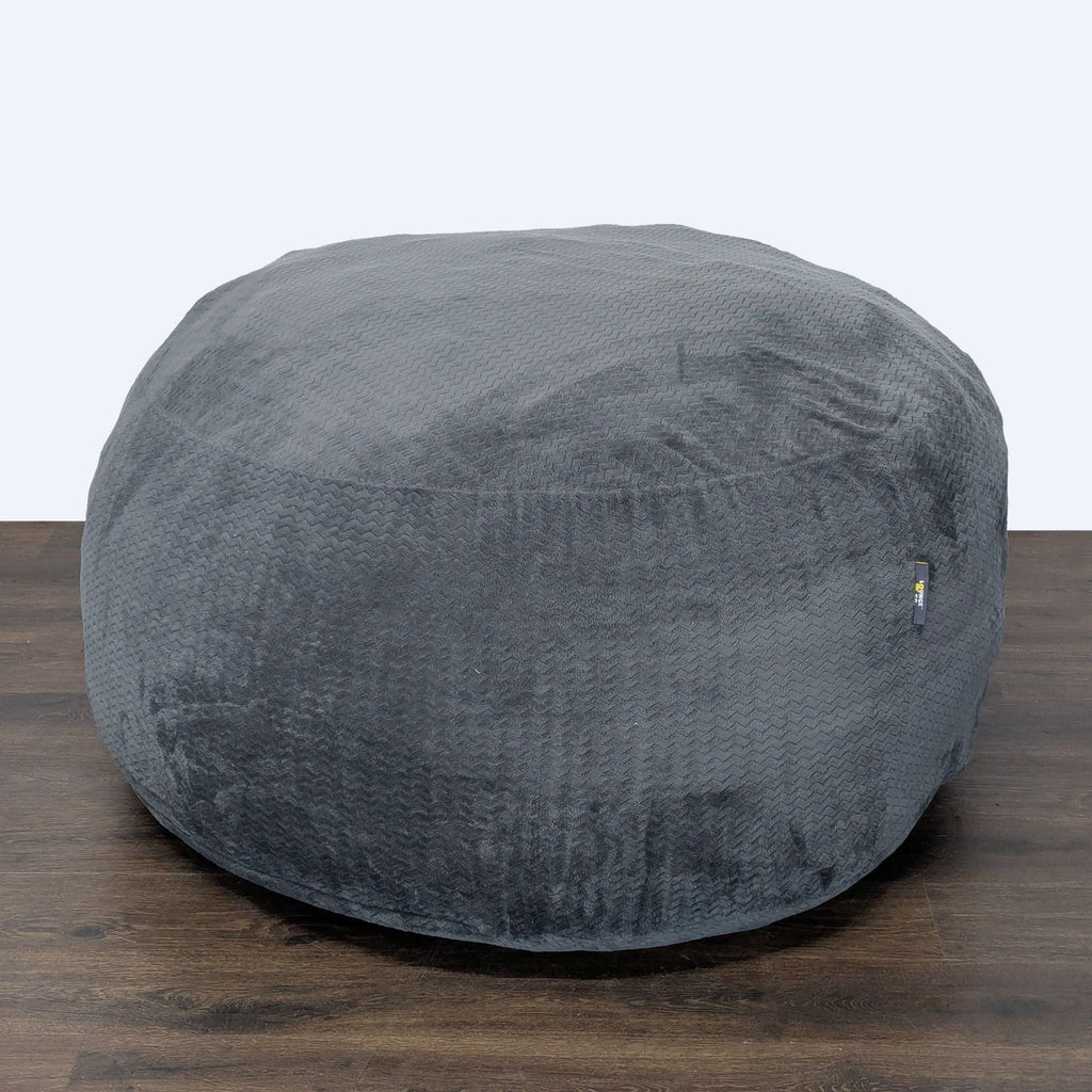 3. Round, textured gray bean bag by Lounge & Co., offering comfortable and stylish seating for kids and adults.
