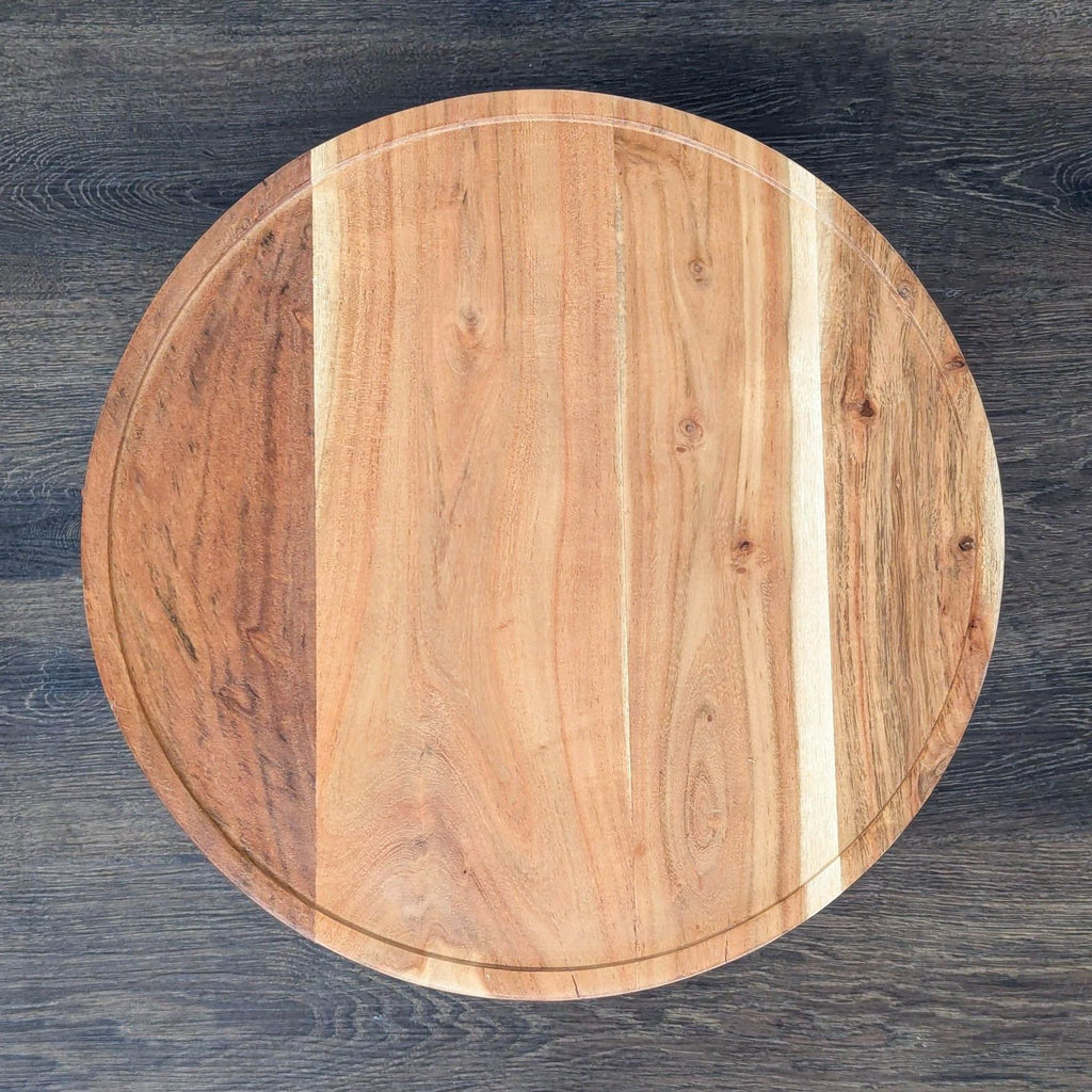 3. Top view of a circular wooden side table with natural wood grain and subtle rim, on dark flooring.