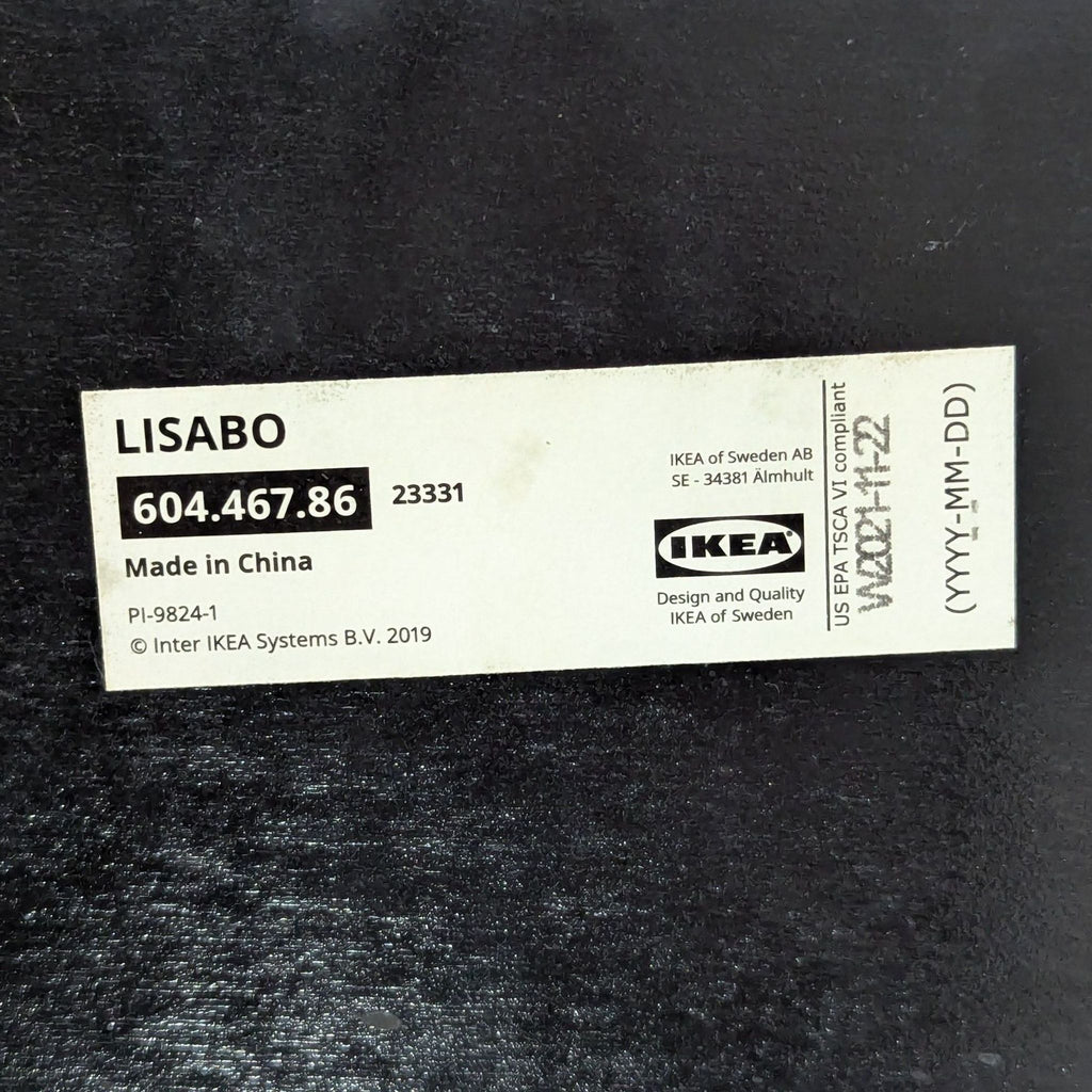 Label on underside of IKEA dining chair, model LISABO, showing product details and serial number.