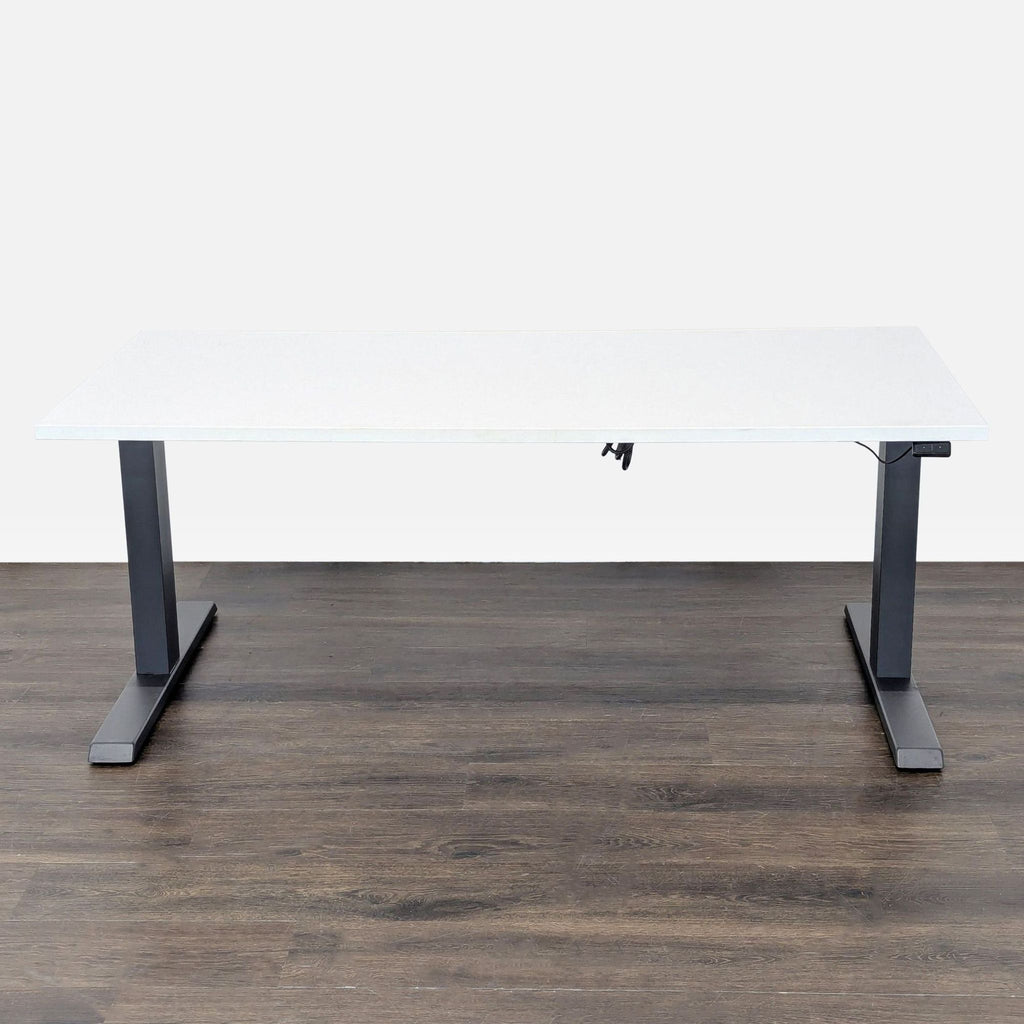 1. Steelcase electric adjustable desk with a white top and gray legs, shown at sitting height on a wooden floor.  