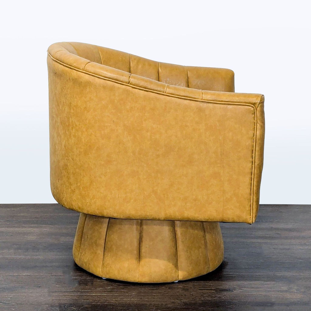 Modern mustard faux leather chair with vertical tufting, cushioned seat, and swivel base; perfect for lounging.