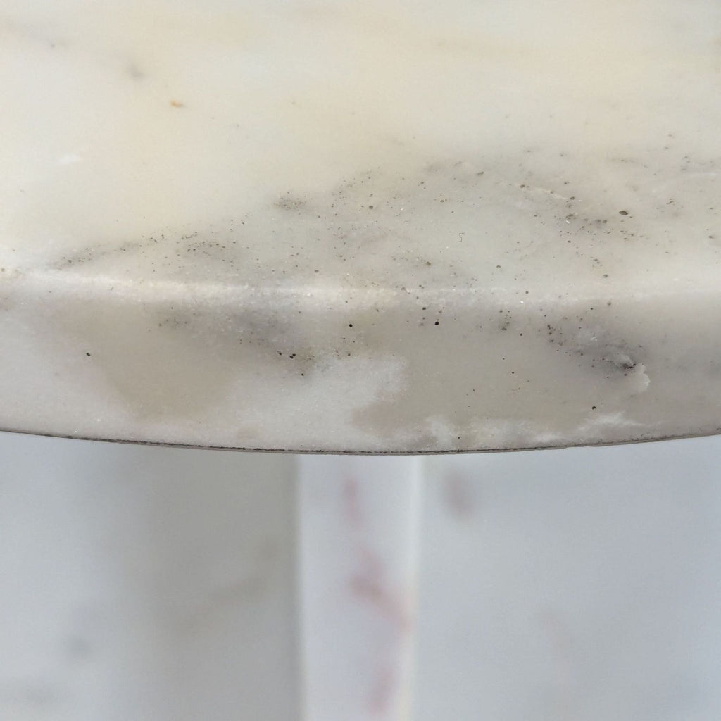 3. Close-up of a marble tabletop, highlighting subtle gray veining and smooth, polished surface.