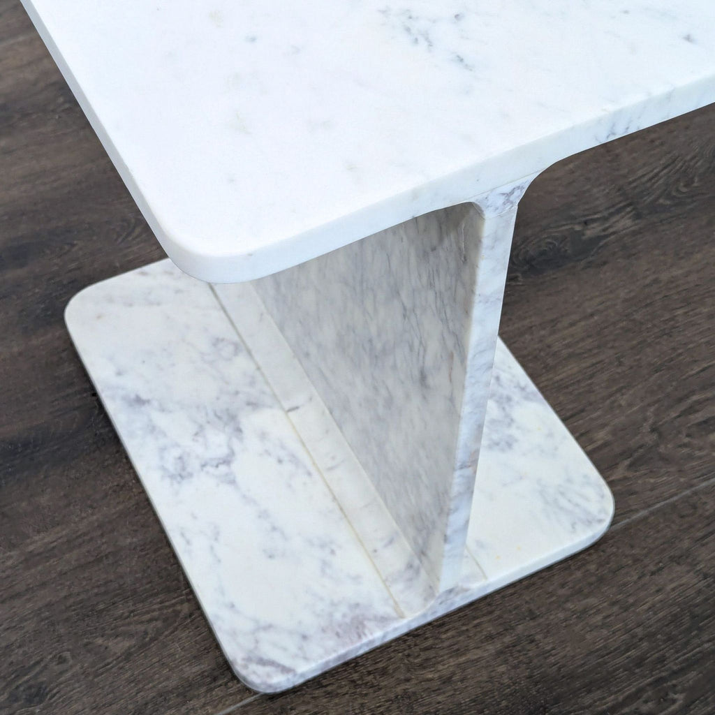3. Marble side table from Nadaal with I-beam inspired form, ideal as a contemporary accent piece.