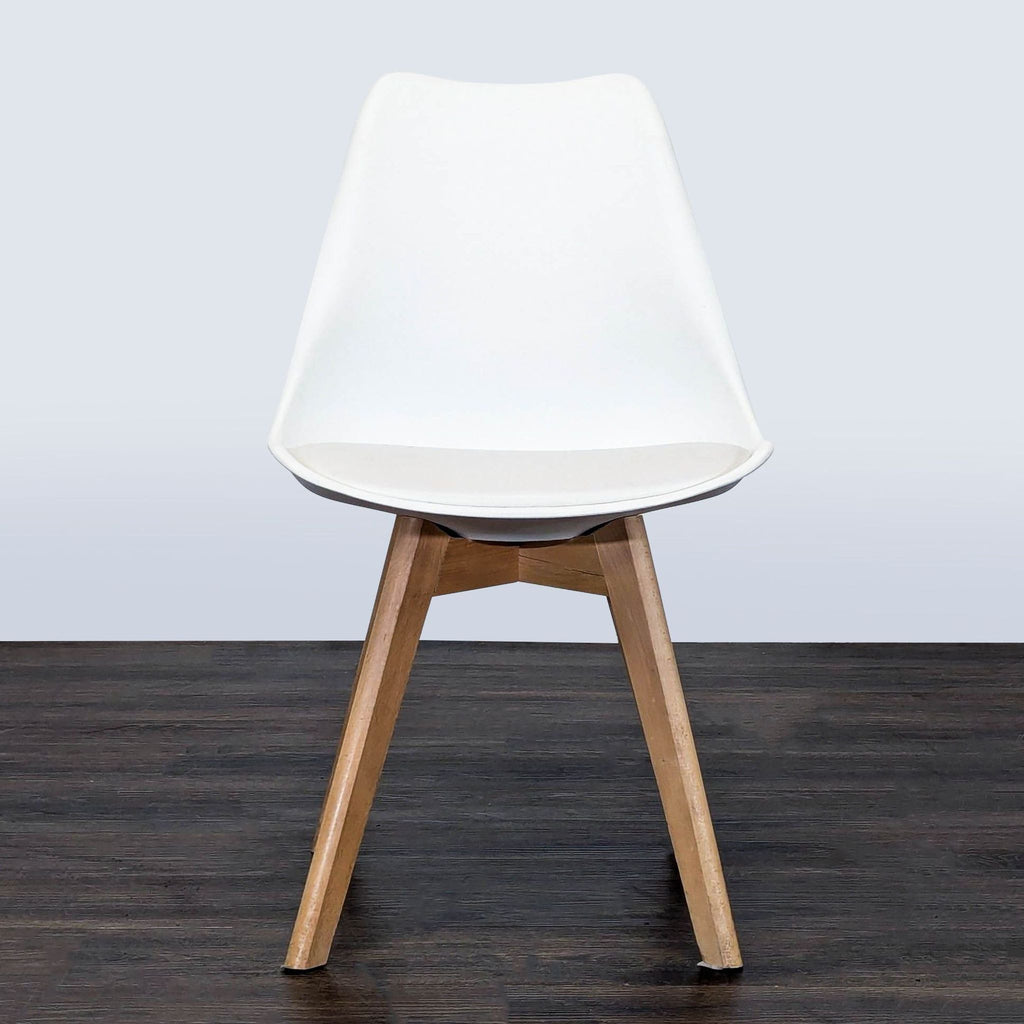 Modern dining chair with matte polypropylene seat, beech wood legs, and soft padded cushion.  