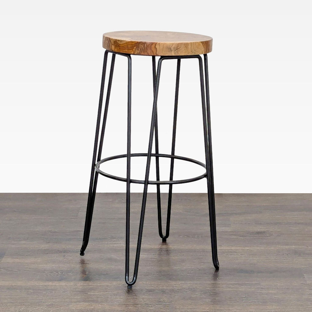 Industrial-style stool with a wood seat from Crate & Barrel, ideal for modern interiors.  