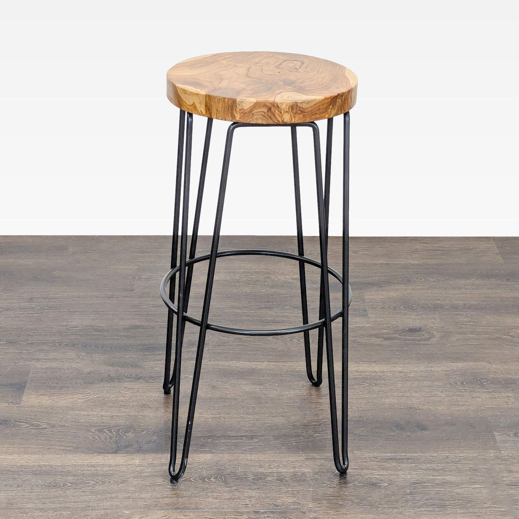 A sleek industrial stool with wooden seat, categorized under Stools, Ottomans & Benches by Crate & Barrel.