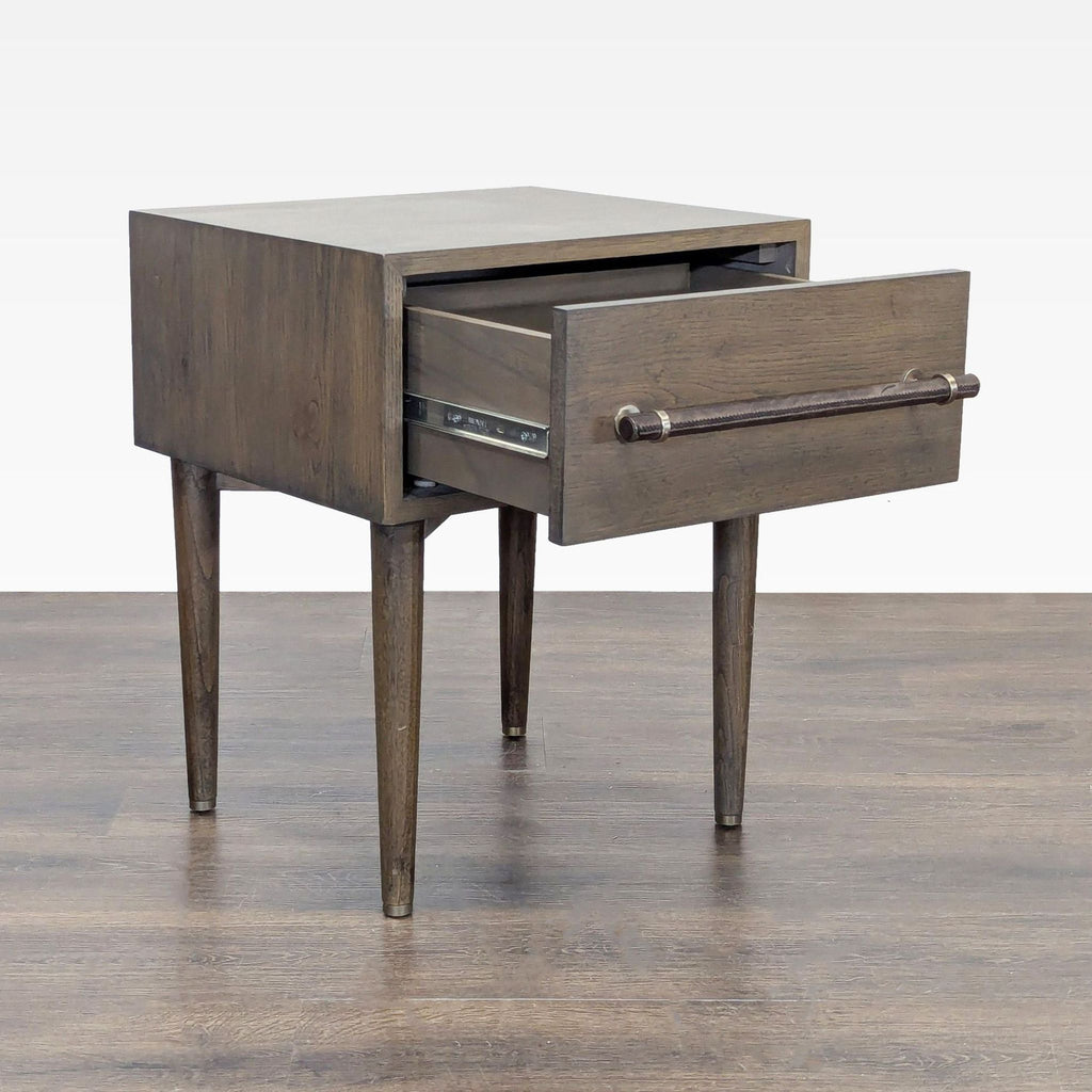 2. Modern West Elm side table in walnut-stained oak and engineered wood, featuring a stitched leather handle.  