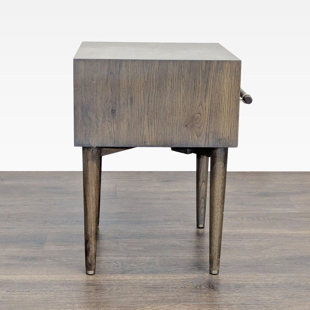 3. Wooden West Elm dresser with leather-wrapped metal pull, hand-stitching, and walnut-stained oak veneer.