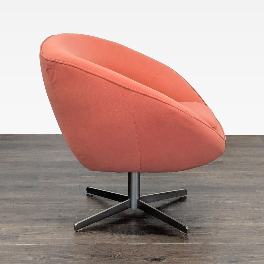 Contemporary lounge chair in warm rust fabric and metal swivel base; compact and stylish seating for any room.