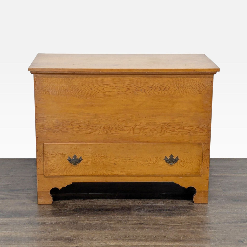 1. Rectangular wooden trunk with a visible drawer at the bottom, featuring ornate metal handles.