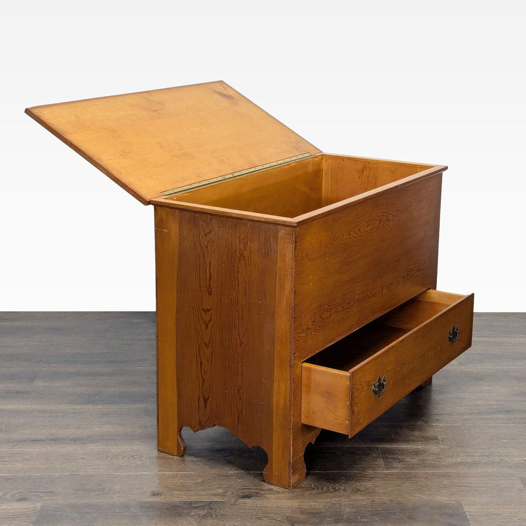 2. Wooden trunk shown with its top lid open and bottom drawer pulled out, revealing storage space.