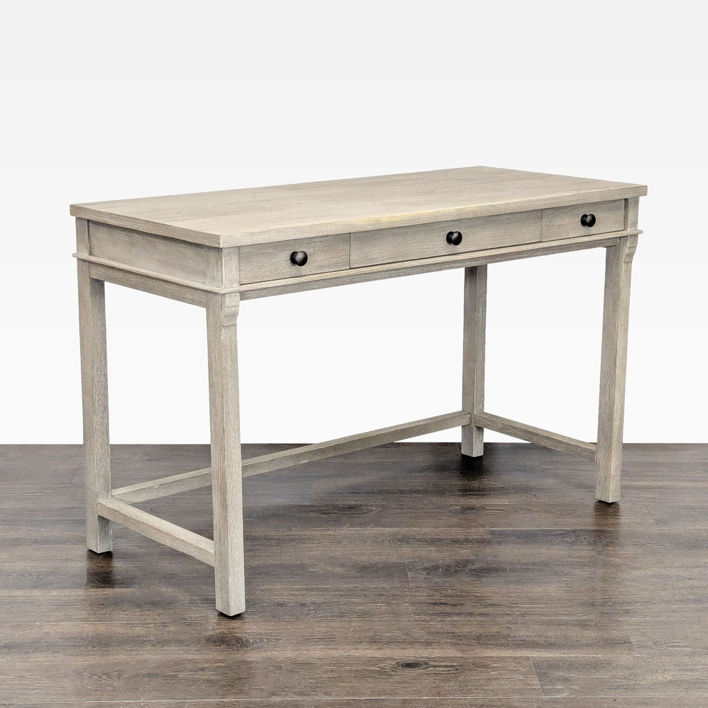 Modern light gray desk featuring three storage drawers, a spacious top, and sturdy construction.