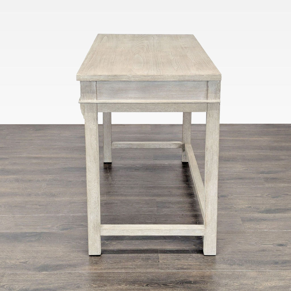 Contemporary desk in gray wood with metal knobs and ample drawer storage, suitable for study or office.