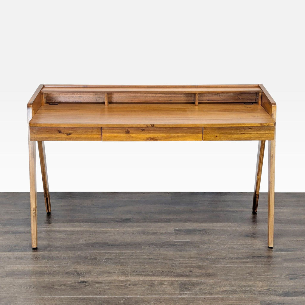 CB2 mid-century modern desk with wood finish, three drawers, and upper shelf for organized storage.