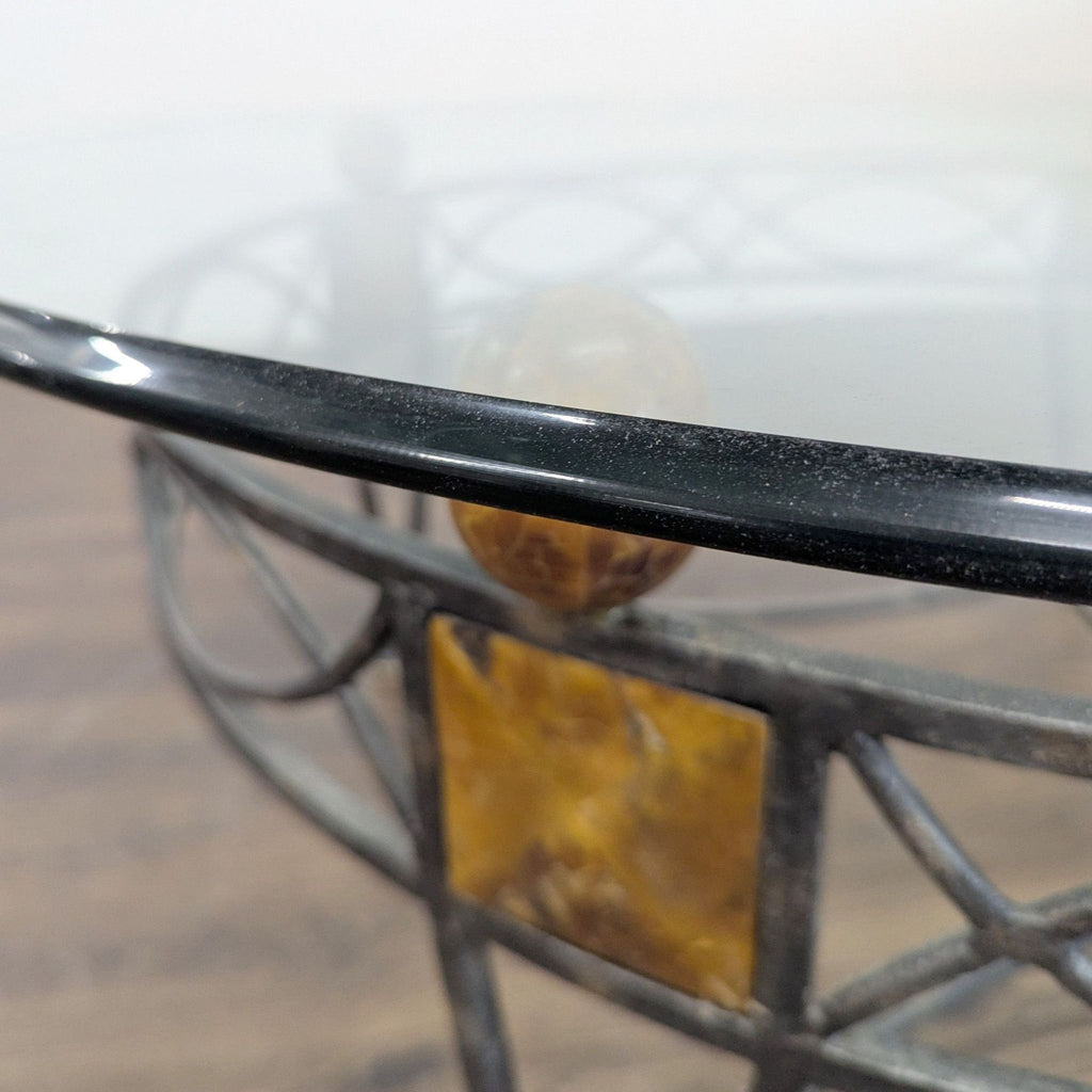 2. Close-up of the coffee table’s glass edge, highlighting the brown marble sphere and square accent on the frame.  