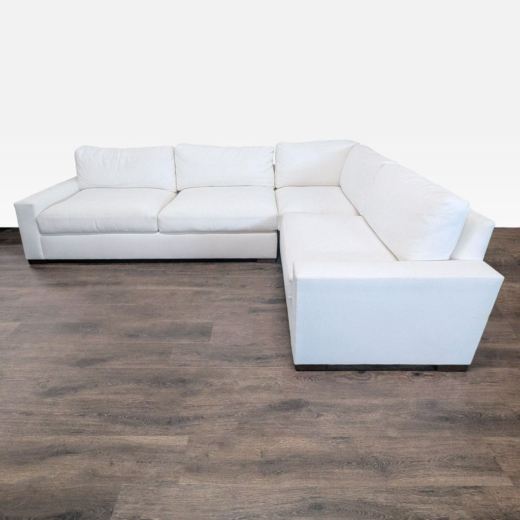 Restoration Hardware L-shaped sectional with white upholstery and modern lines, offering spacious, comfortable seating.