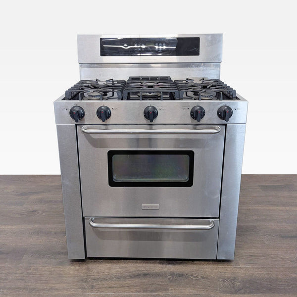 1. Frigidaire stainless steel stove with 5 burners, spacious oven with window, and bottom broiler drawer.