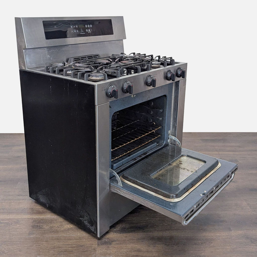2. Used Frigidaire gas stove, featuring multiple burners, control knobs, and a see-through oven door.