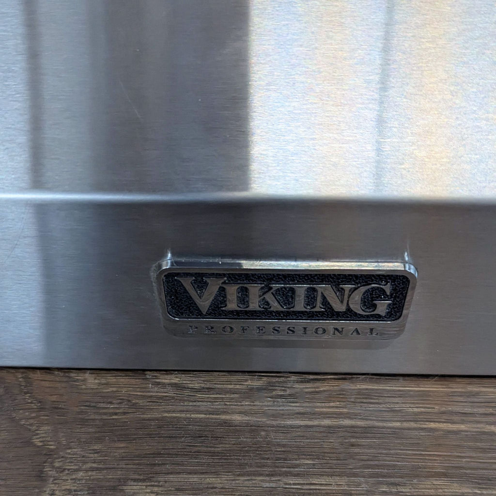 3. Detailed shot of the Viking Professional brand logo on a stainless steel appliance surface.