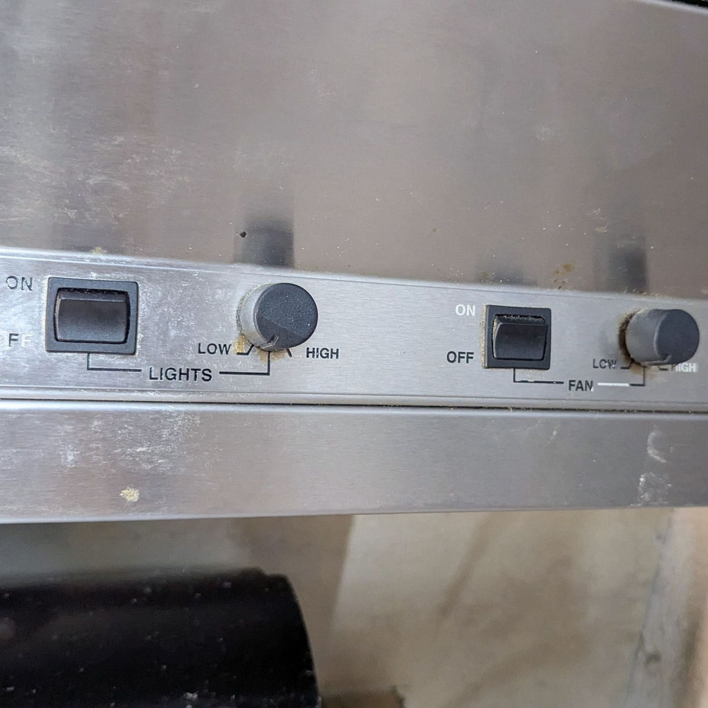 2. Close-up of Viking range hood control panel, featuring switches and dials for fan and light settings.