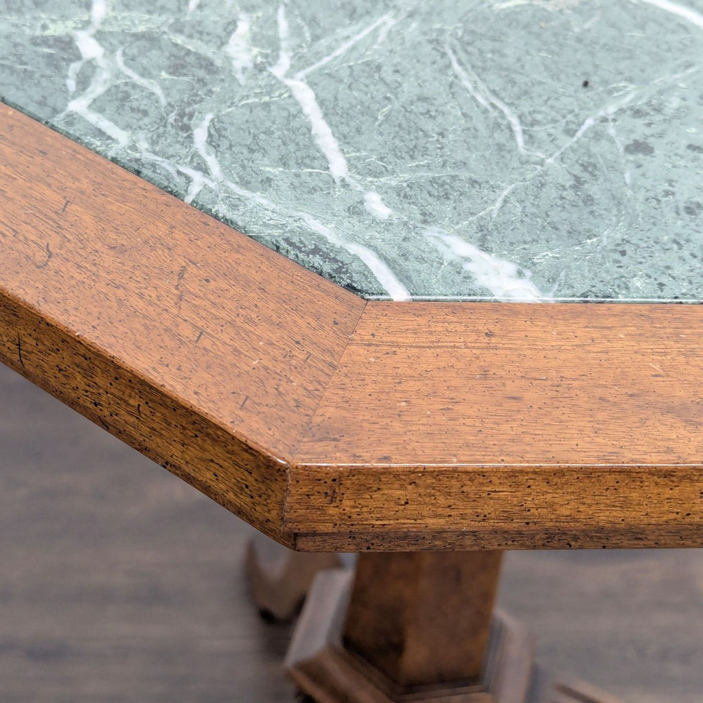 3. Close-up of a green marble tabletop set in a wooden frame, showing craftsmanship detail on a side table.