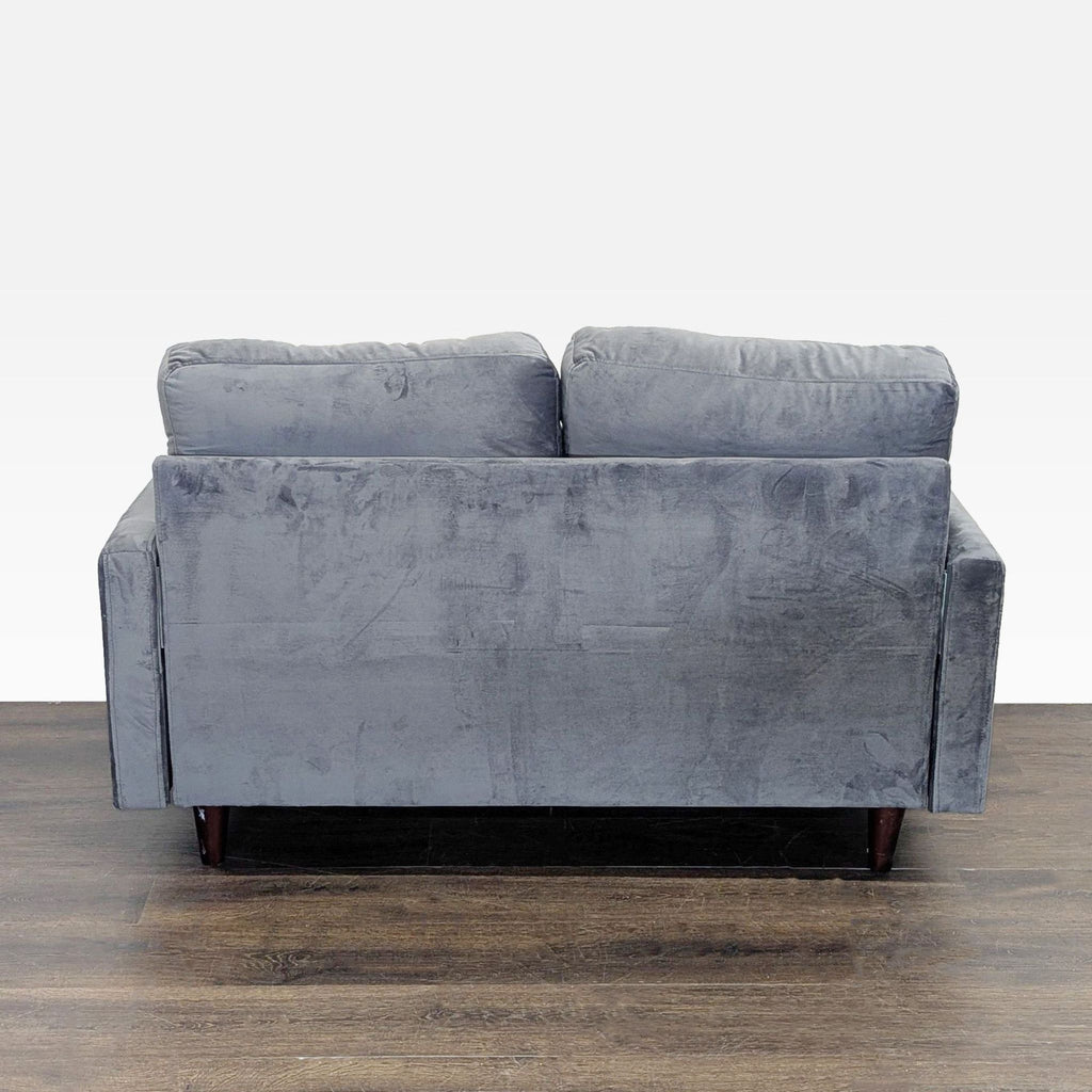 Contemporary loveseat featuring soft gray velvet upholstery, sleek tufting, and clean wooden legs.