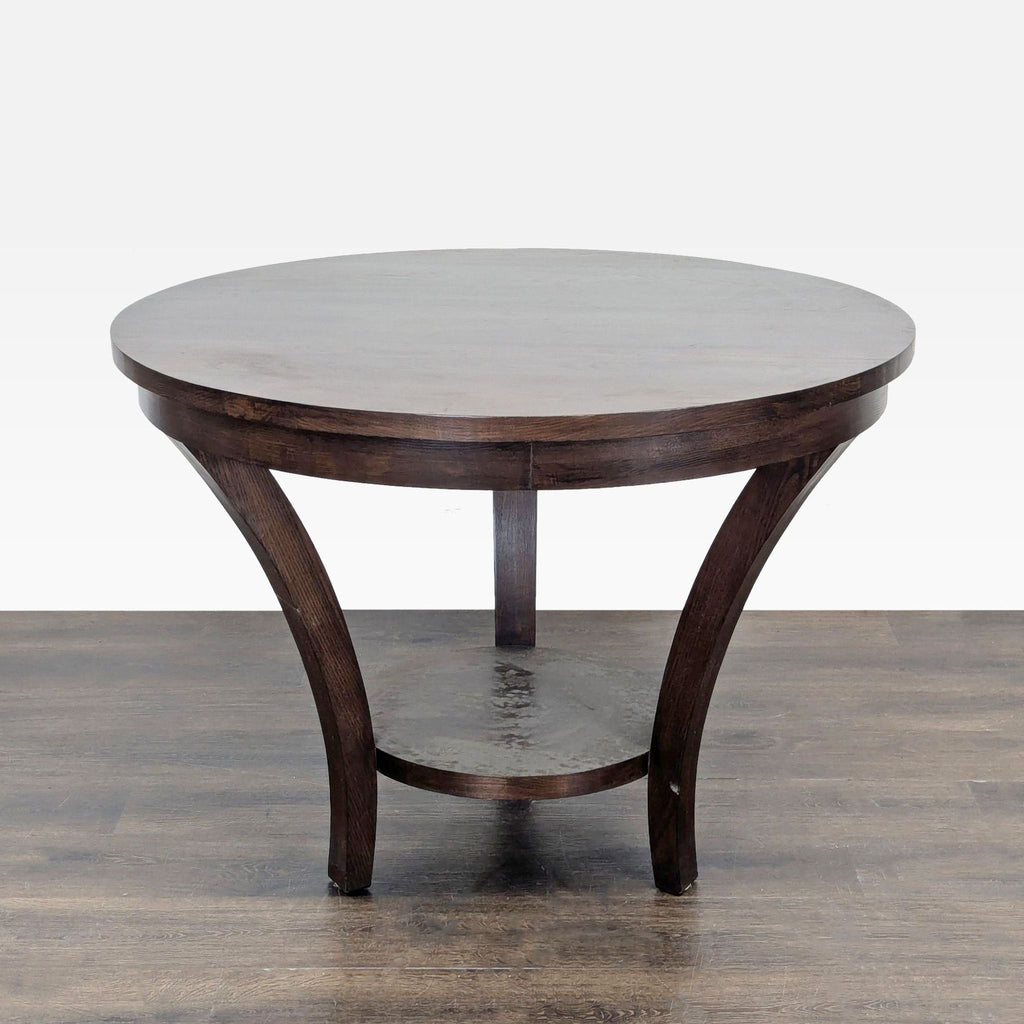 3. Elegant round dining table with flared wooden legs and a small shelf beneath for added storage.