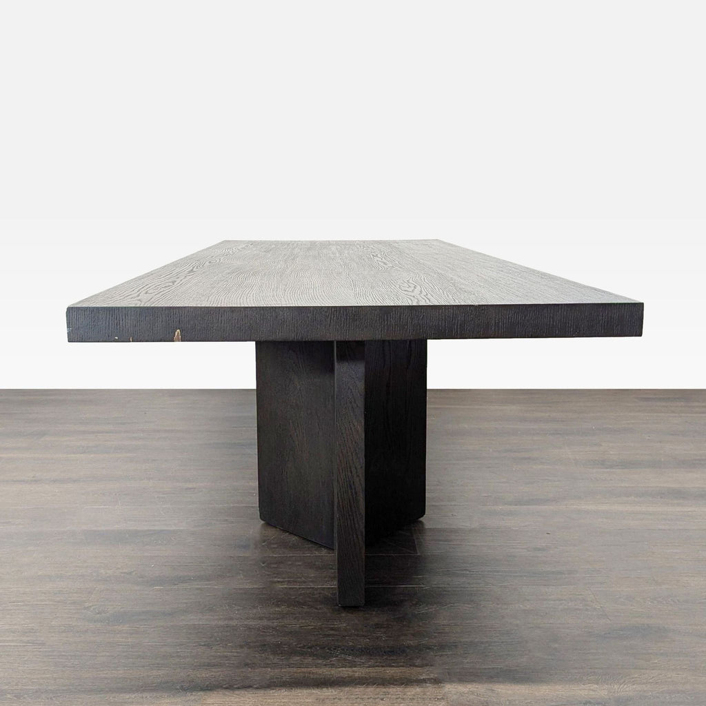 2. Side view of a modern Restoration Hardware dining table, featuring a wide slab top and sturdy base.
