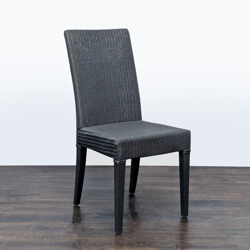 JANUS et Cie woven dining chair featuring a wire frame wrapped in paper, resembling wicker, on solid wood legs.  