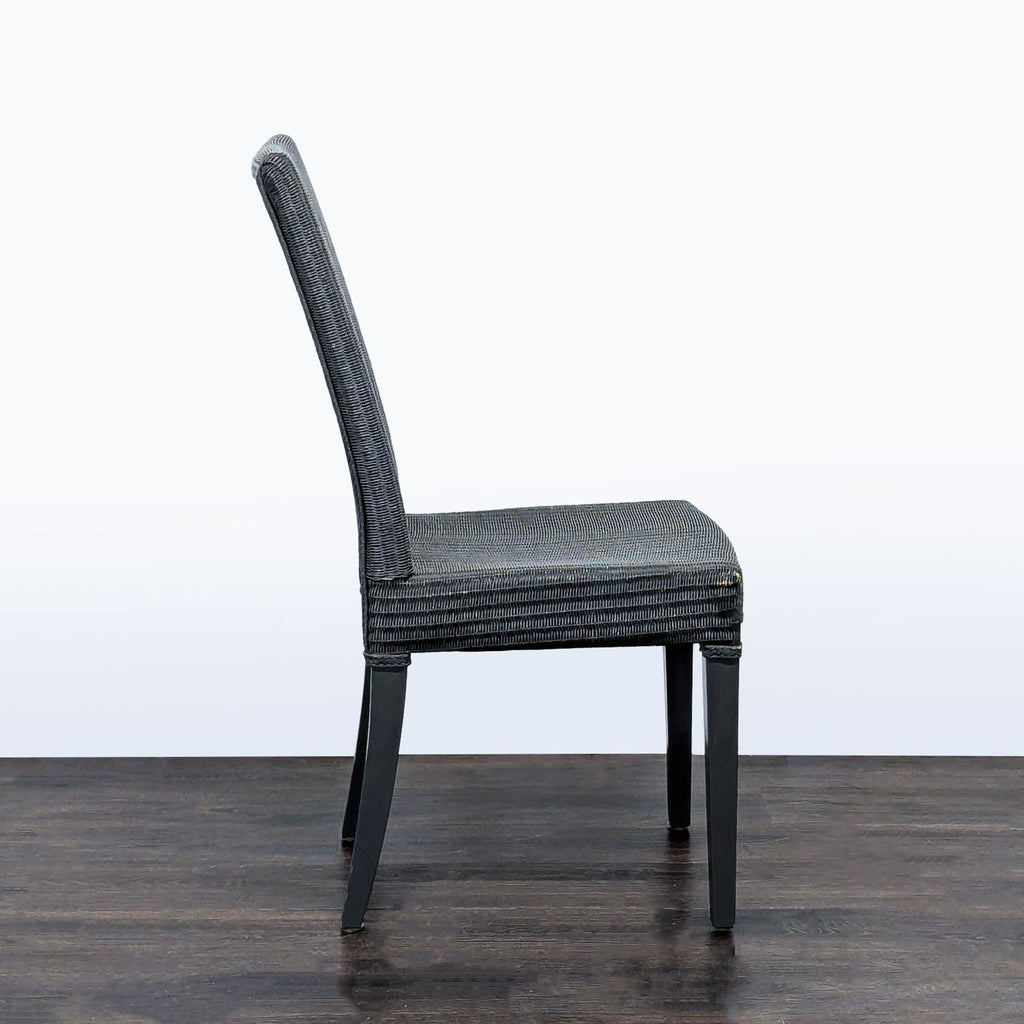 Modern JANUS et Cie dining chair with a sculpted woven seat and back and sturdy wood legs for elegant dining spaces.