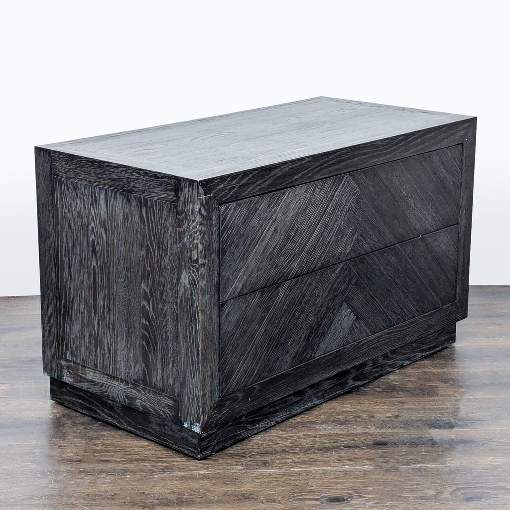 3. Angled view of a Restoration Hardware end table with two drawers and a textured, herringbone wood finish.