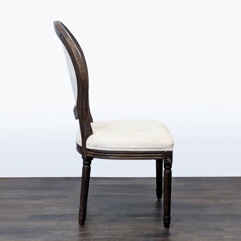 Upholstered dining chair in French style with carved detailing, Restoration Hardware brand.