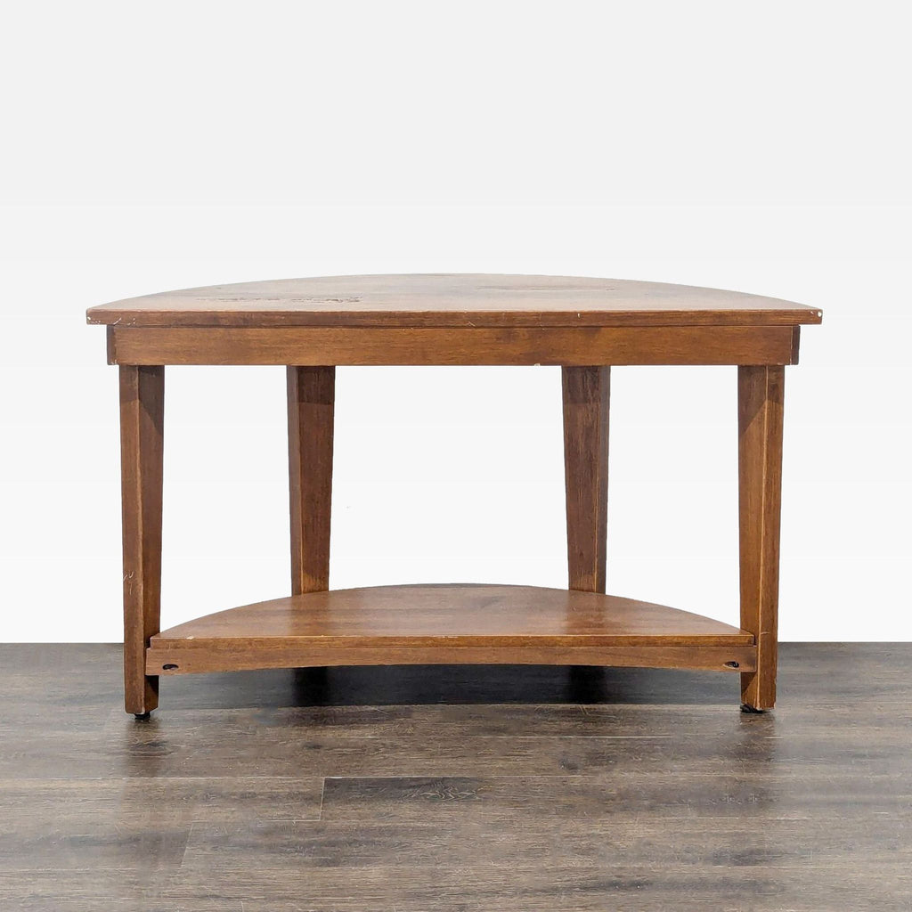 1. Front view of a Pottery Barn wooden console table with a half-moon shape and lower shelf, on hardwood floor.
