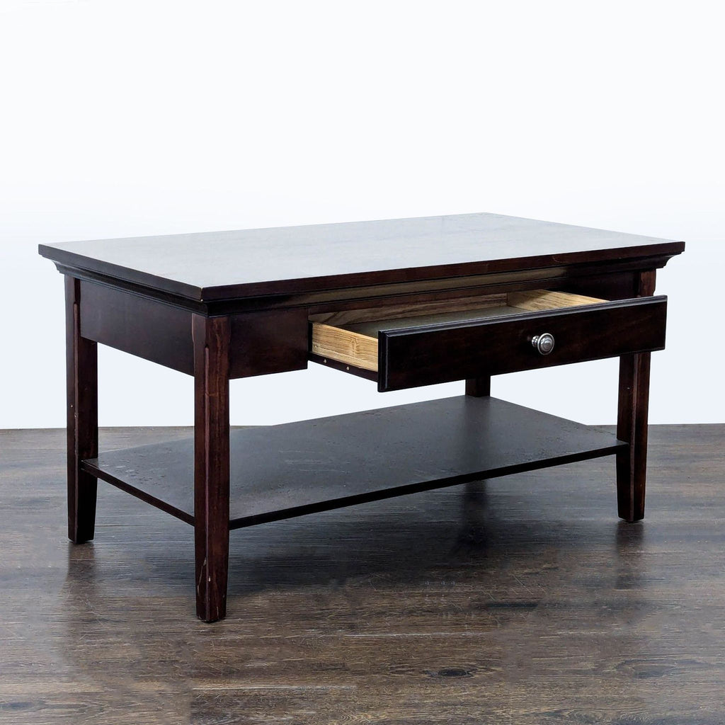 2. Angled view of a dark wood coffee table with its drawer open, revealing interior storage space.