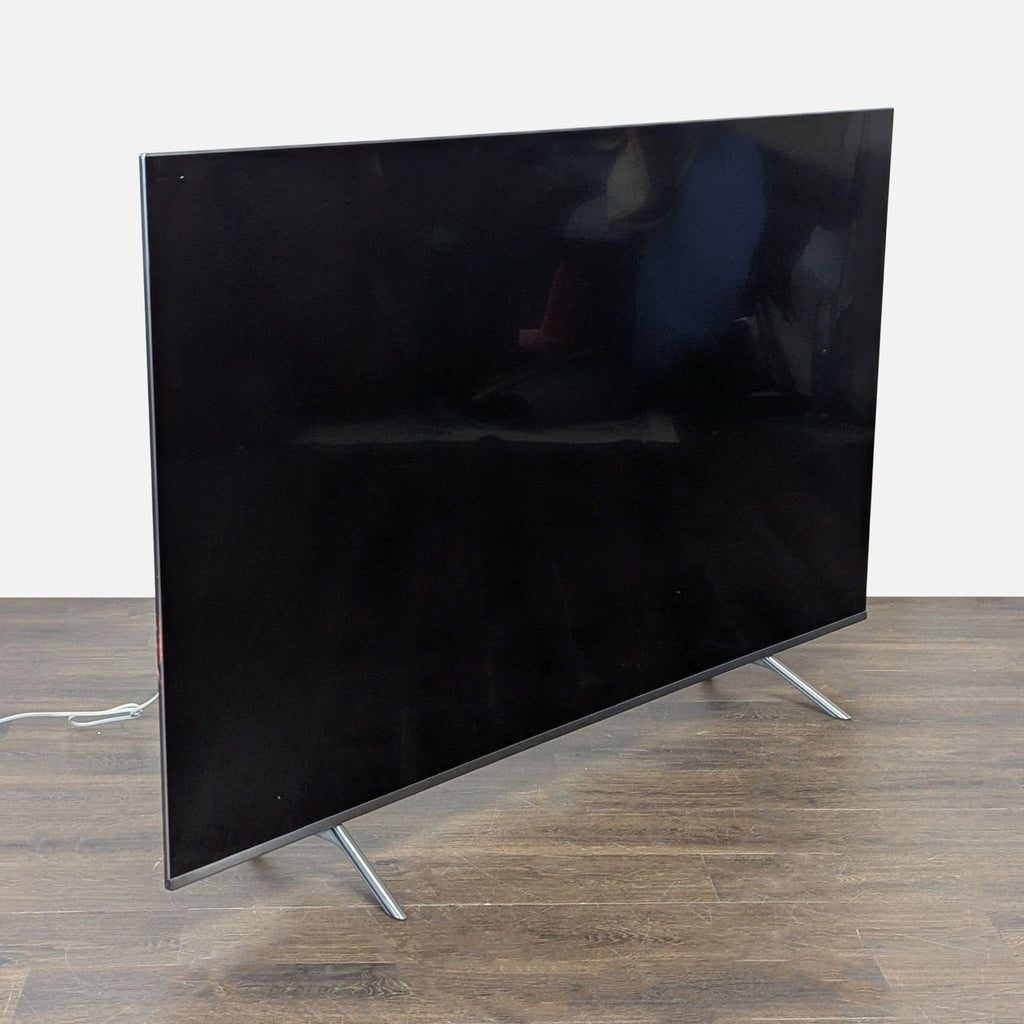 Samsung television shown without One Connect Box; additional purchase required for full use.  