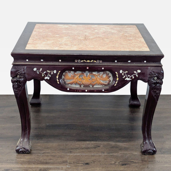 1. End table with a pink marble top, floral mother of pearl inlay, and carved deity figures on dark wood legs.