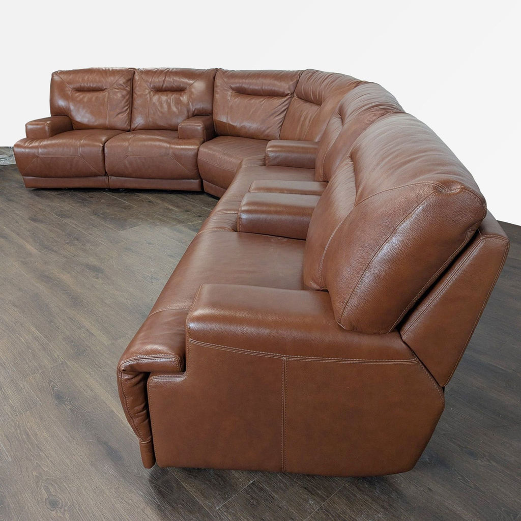 3. Spacious brown leather sectional couch featuring armrests and durable upholstery, ideal for family gatherings.