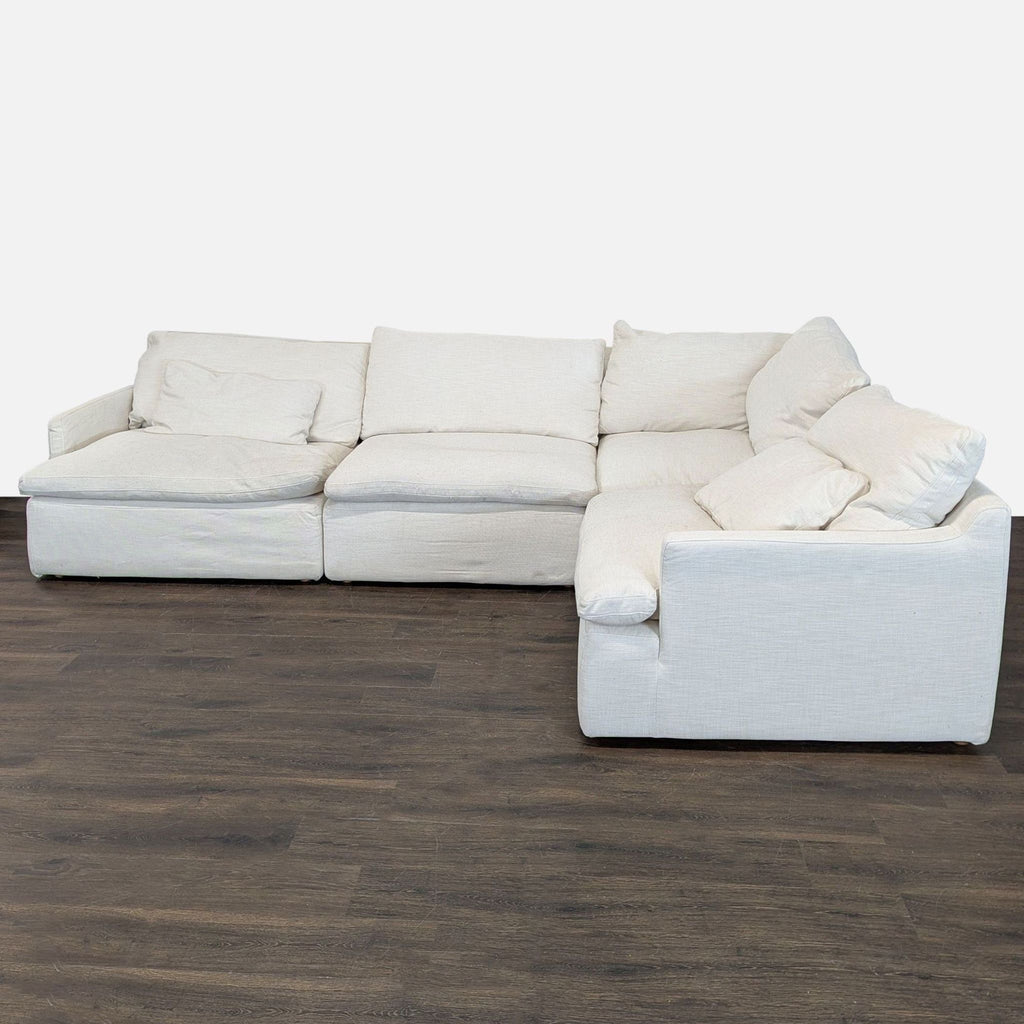 Cream Restoration Hardware sectional with plush cushions and L-shape design, offering modern comfort and style.