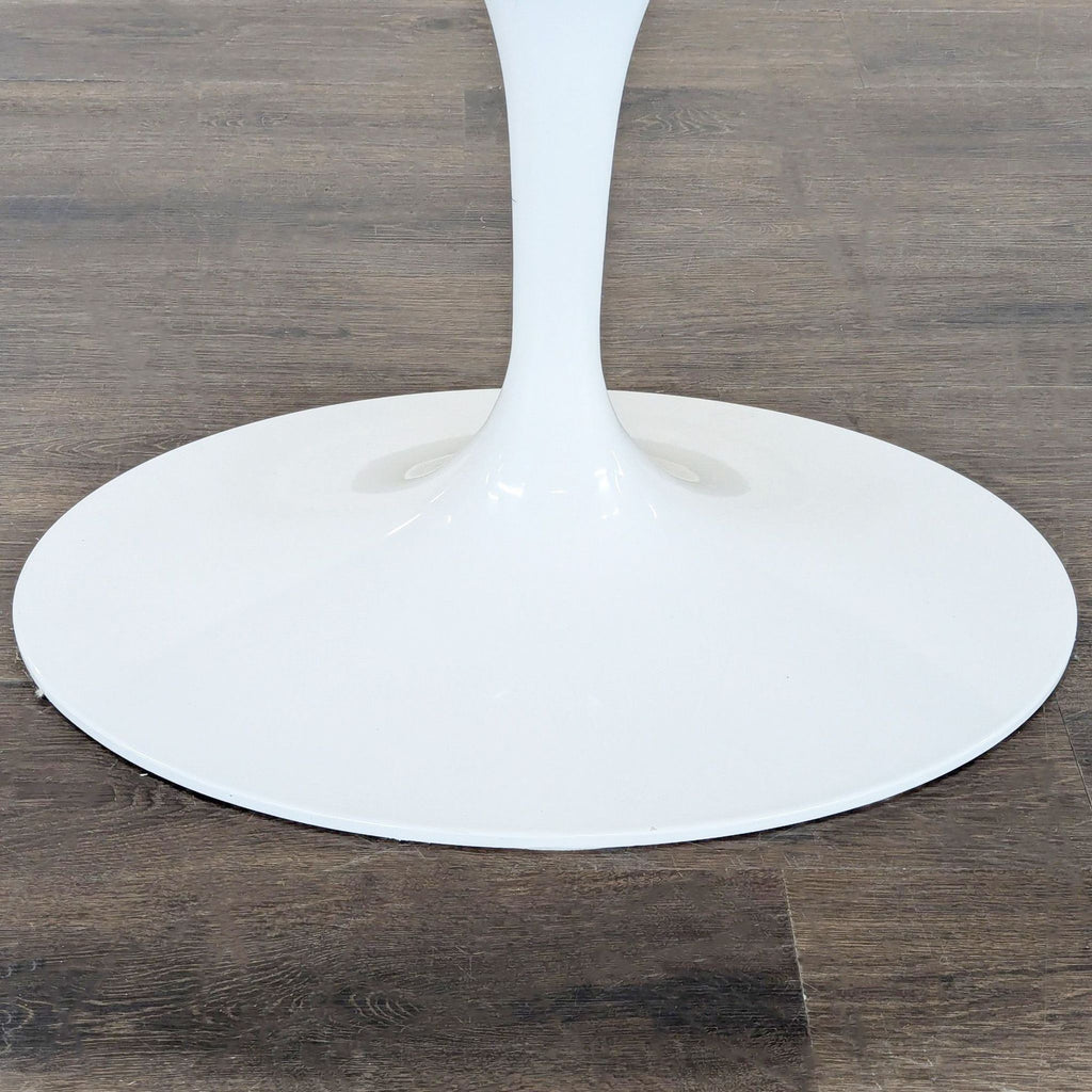 Rove Concept oval dining table, inspired by mid-century style, with a sleek cast aluminum pedestal base.