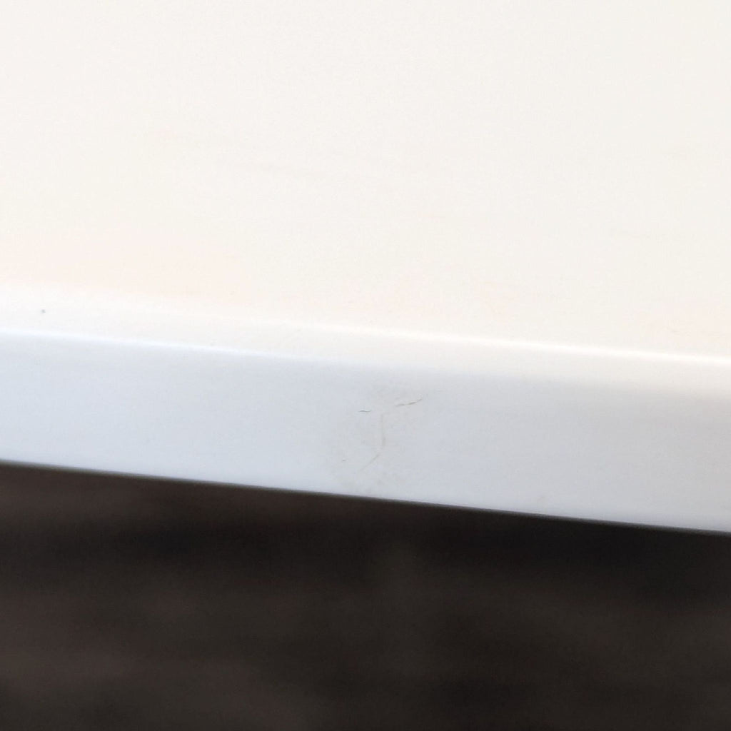 Mid-century modern-inspired tulip table with smooth white surface and sturdy, rounded pedestal base.