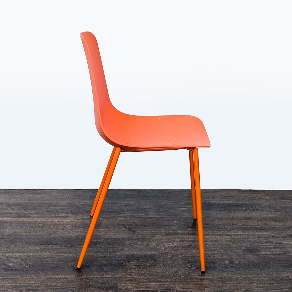 2. Sleek dining chair featuring minimalist design and a comfortable upholstered backrest.