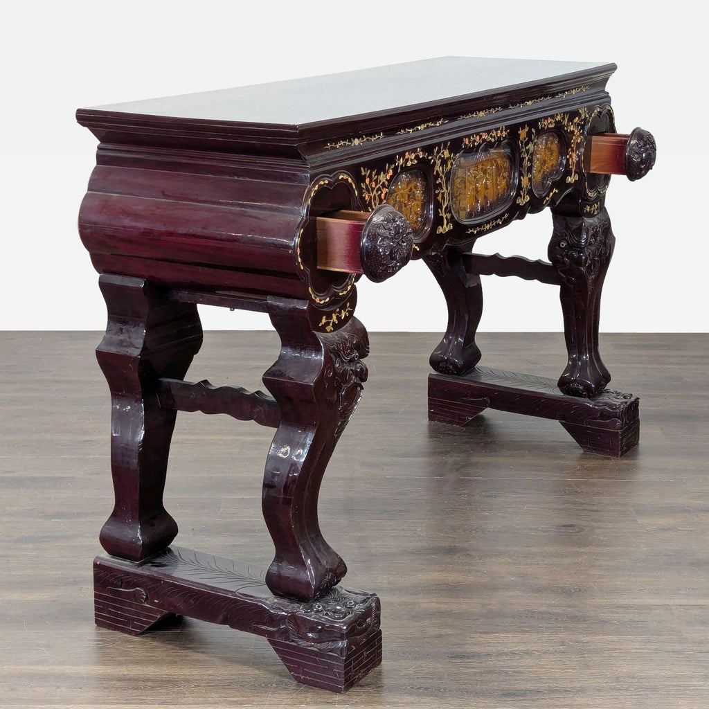 Console table featuring carved figures, animals, florals, deity base, two drawers, and mother of pearl inlay.  