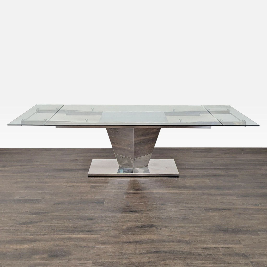 2. Rectangular extendable dining table with clear glass top and central metallic base, expands for extra seating.