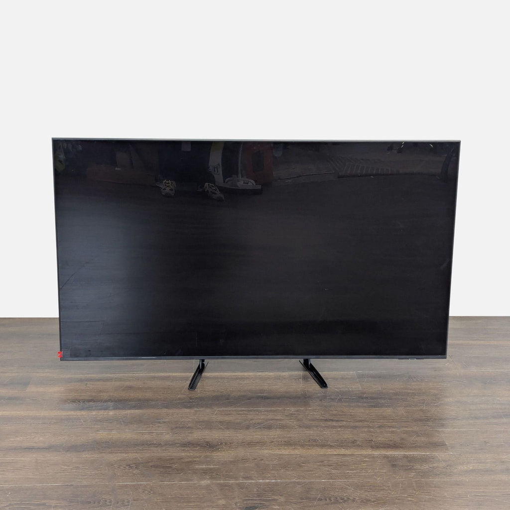 Samsung 65-inch 4K UHD Smart TV with sturdy legs, sleek design, and popular streaming apps displayed on screen.